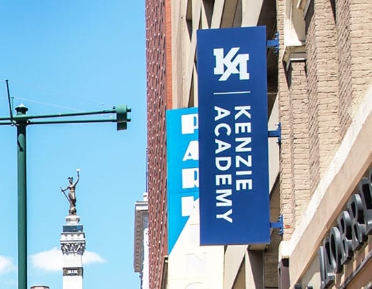 Kenzie Academy logo on flag outside offices