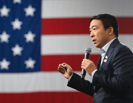 Photo of Andrew Yang in front of American flag