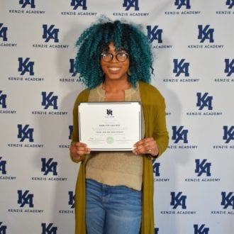 Photo of Kenzie Academy Software Engineering grad Darlyze Calixte holding her certification.