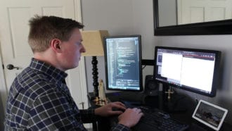 photo of Kyle Negley coding at computer