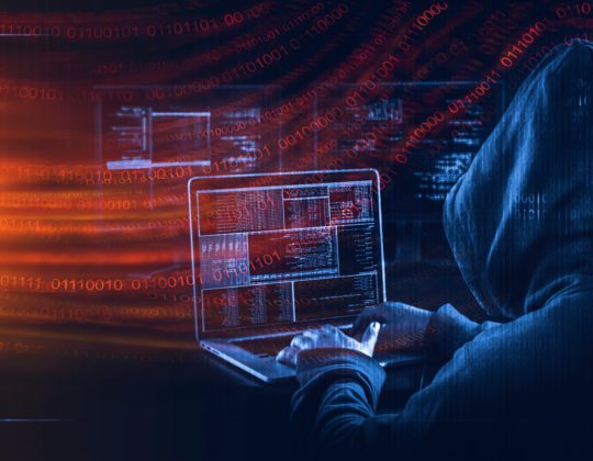 Cyberattack represented by hooded hacker on computer