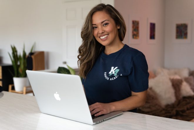 female full-stack web developer coding at laptop